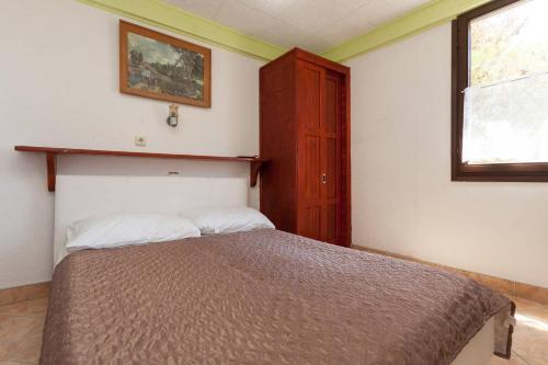 Ένα ή περισσότερα κρεβάτια σε δωμάτιο στο Apartmani Antonella
