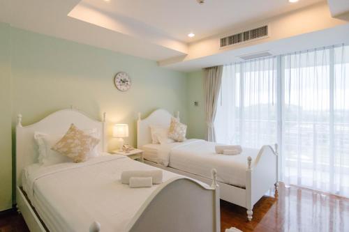 Postel nebo postele na pokoji v ubytování SeaRidge Hua Hin Resort & Poolvilla