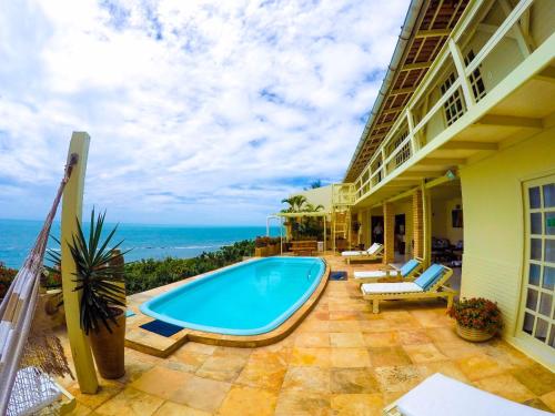 a swimming pool on the patio of a house at Pousada Azul Marinho in Canoa Quebrada