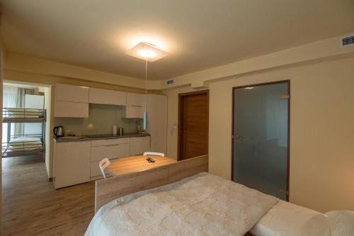 a bedroom with a large bed and a kitchen at Wiktoria in Wisła