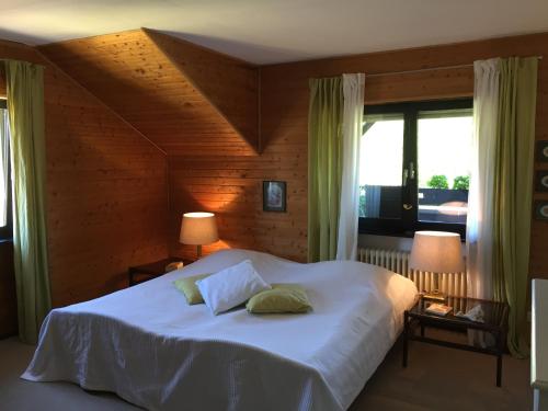 a bedroom with a white bed with two pillows on it at Vias Ferienwohnungen in Pünderich