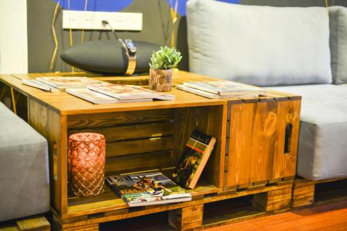 a wooden coffee table with books and magazines on it at SAHIL Hostel & Hotel in Baku