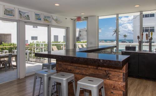 a kitchen with a counter with stools and a view of the ocean at Premiere Hotel in Fort Lauderdale