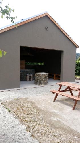 a building with a picnic bench in front of it at Gospodarstwo Agroturystyczne-Pensjonat SAD in Podgórzyn