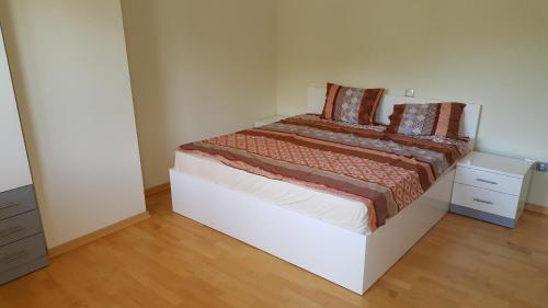 a small bedroom with a bed and a dresser at Park Beach Apartment in Ohrid