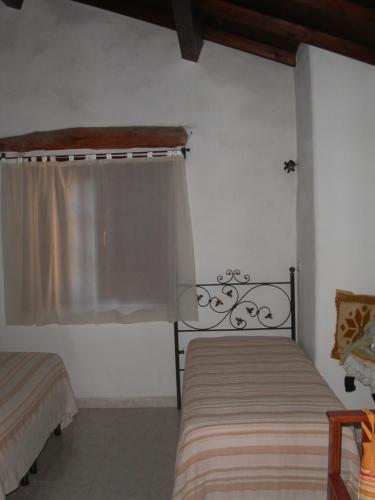 A bed or beds in a room at Locanda La Rosa