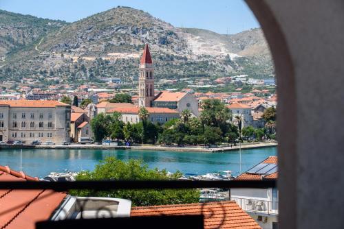 a view of a town with a river and a city at Apartments & Rooms Žaja in Trogir