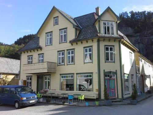 a house with a car parked in front of it at Rongahuset BnB in Evanger