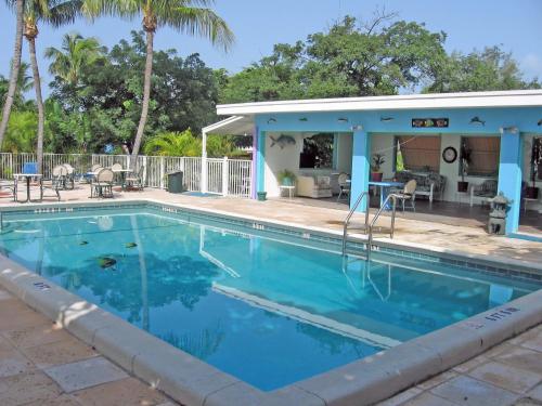 a swimming pool in front of a house at Coconut Cay Resort in Marathon
