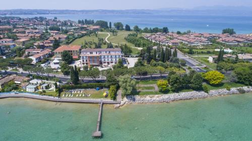 an aerial view of a resort on the water at Hotel Mirabello in Sirmione