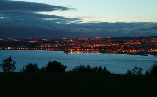 a view of a large body of water at night at Quinta Tagus in Costa da Caparica
