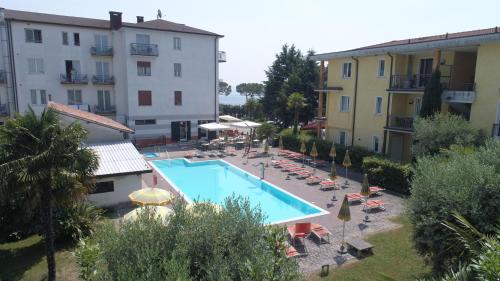 a view of a swimming pool next to a building at Hotel Mirabello in Sirmione