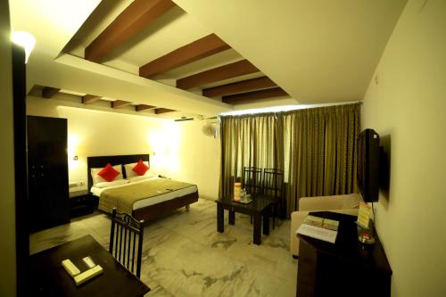 a hotel room with a bed and a couch at Nayagara Hotel in Chennai