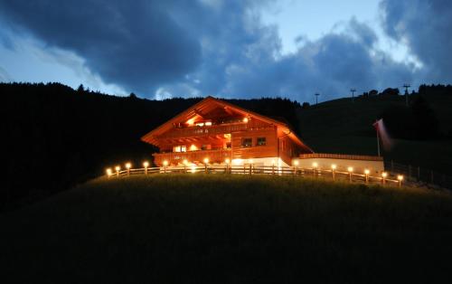 a wooden barn lit up at night with lights at Residenz Erschbaum in Valdaora