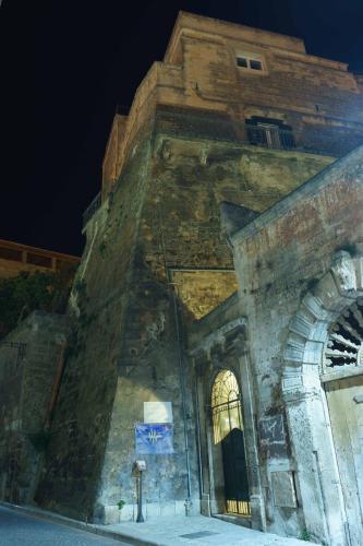 a large stone building with a window on the side at Antica Torre di Iuso in Matera