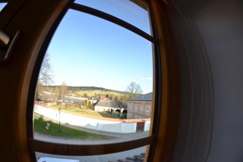 a window view of a town from a train at Pension U Kostela in Frymburk