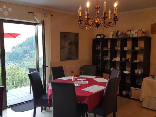 a dining room with a red table and chairs at Haus Grünewald in Zell an der Mosel