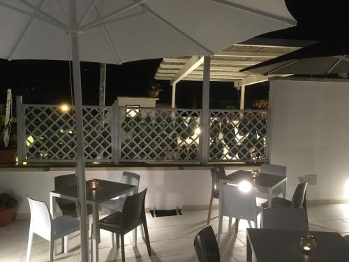 a restaurant with tables and chairs and an umbrella at B&B Salentus in Gallipoli