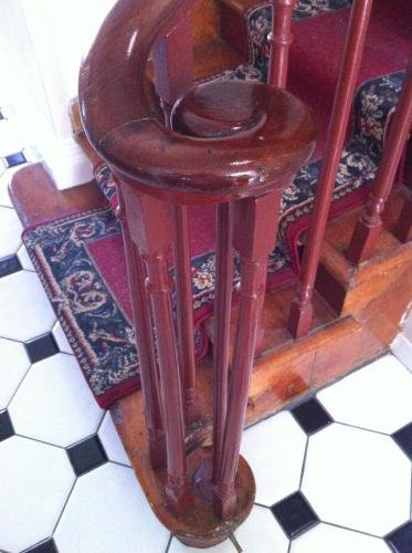 a wooden chair sitting on top of a floor at Pring Guesthouse in Hamilton