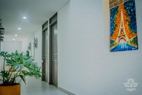 a painting of the eiffel tower on a wall at Casa del Sol in Villavicencio