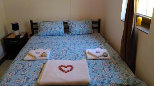 a bedroom with a bed with two pillows on it at Apartment Mond in Virpazar