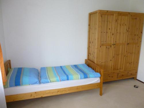 a bedroom with a bunk bed and a wooden cabinet at Anton Schuler in Niedenstein