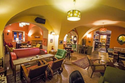 a living room with a couch and tables and chairs at MuziKafe - Home of Culture in Ptuj