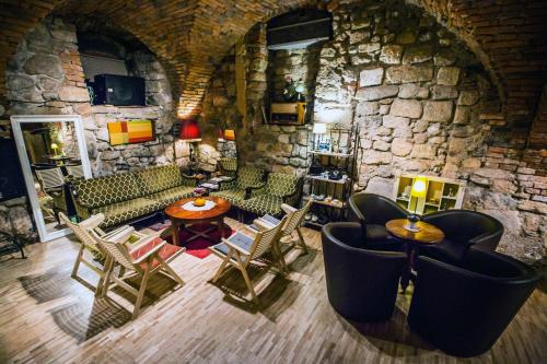 an overhead view of a living room with a stone wall at MuziKafe - Home of Culture in Ptuj