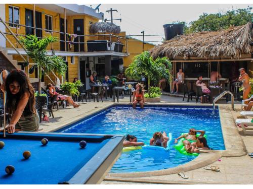 people are swimming in a pool at Hostel Nirvana Taganga in Taganga
