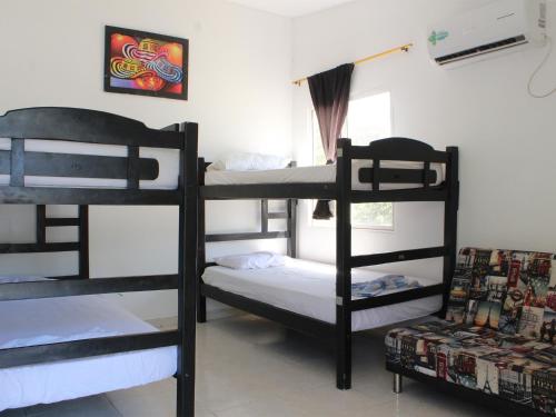 a bunk bed with two bunk beds in a room at Hostel Nirvana Taganga in Taganga