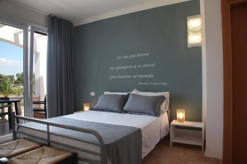 a bedroom with a bed with words on the wall at Villa Giulia&Gaia - Guest House in Nardò