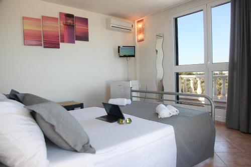 a bedroom with a bed with a laptop on it at Villa Giulia&Gaia - Guest House in Nardò