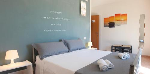 a bedroom with a bed with two towels on it at Villa Giulia&Gaia - Guest House in Nardò