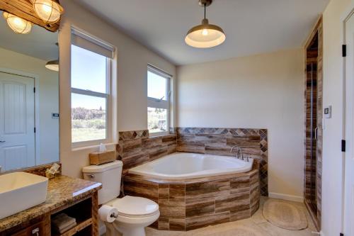 a bathroom with a tub and a toilet and a sink at Sevier River Retreat in Hatch