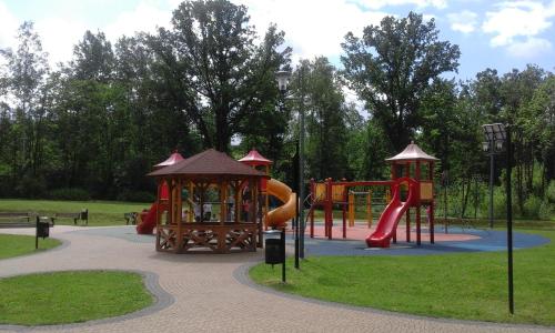 a park with a playground with a slide at Apartament Parkowy Rabka in Rabka-Zdrój