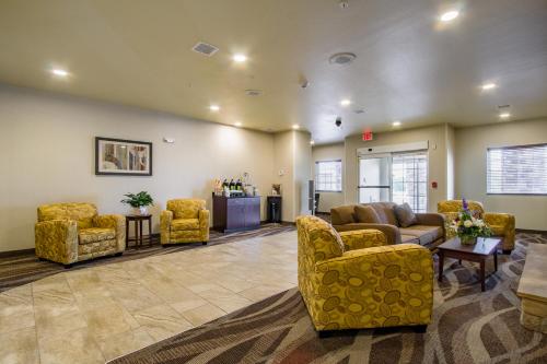 a lobby with couches and chairs in a waiting room at Cobblestone Hotel & Suites - Orrville in Orrville