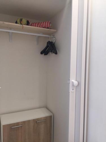 a room with a closet with a shelf and shoes at San Domenico in Mola di Bari