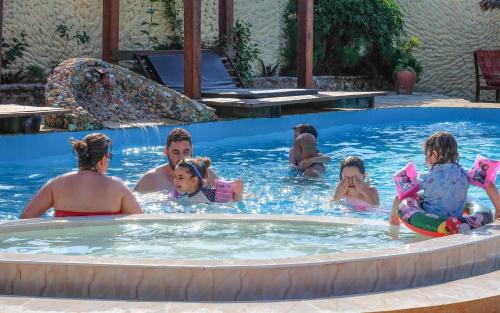 a group of people in a swimming pool at Seasons Lodge Zanzibar in Pongwe