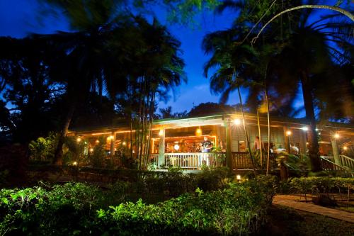 a house with lights on it at night at Tufi Resort in Tufi