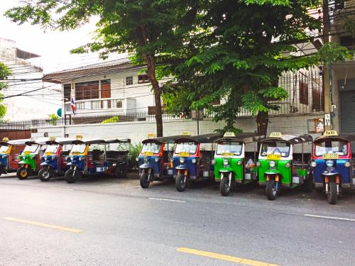 a row of scooters parked on the side of a street at Rio Monte Residence in Bangkok
