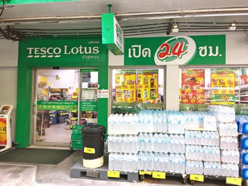 a tesco lotus store with a large display of bottled water at Rio Monte Residence in Bangkok