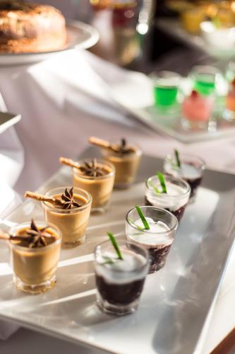 a white table with several small cups of desserts at Plataran Borobudur in Borobudur