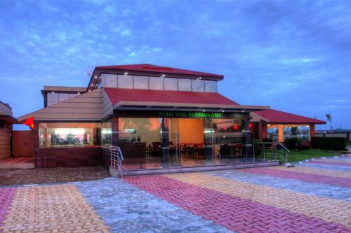 a building with a restaurant with a red roof at Bandipur Wildlife Resort & Spa, Bandipur in Bandipūr
