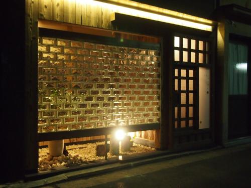 a brick wall with a light in a window at Koume no Hanare コウメノハナレ in Kyoto