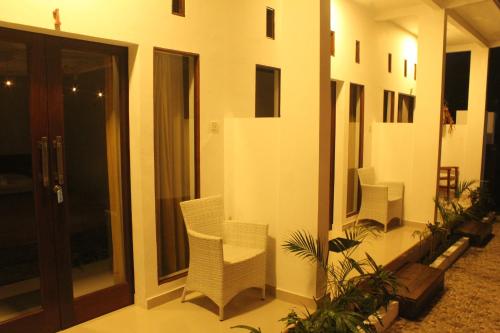 a room with some chairs and a building at Mahi Mahi House in Nusa Lembongan