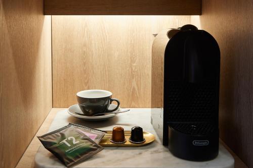 a coffee maker and a cup on a table at Tribe Perth Kings Park in Perth