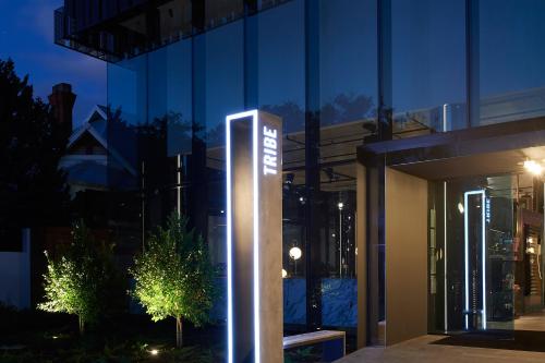 a sign in front of a building at night at Tribe Perth Kings Park in Perth