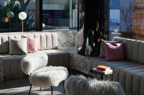 a living room with two couches and a table and chairs at Tribe Perth Kings Park in Perth