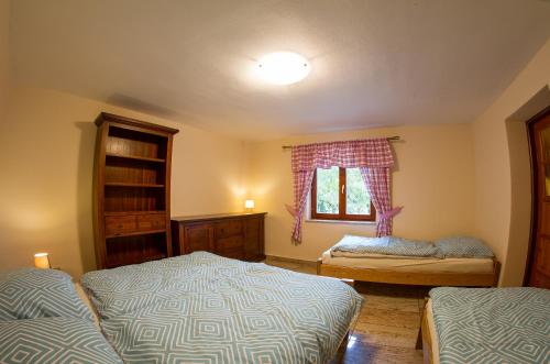 a bedroom with two beds and a window at Burg nad Banskou Štiavnicou in Štiavnické Bane