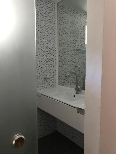 a bathroom with a sink and a mirror at Cabilao Sunset Dive & Beach Resort in Loon